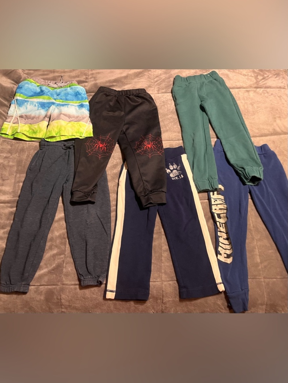 5 pairs of pants and 1 pair of swim trunks size 5/6